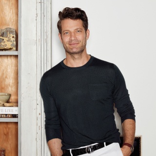 A portrait of the designer Nate Berkus set against the backdrop of his home.