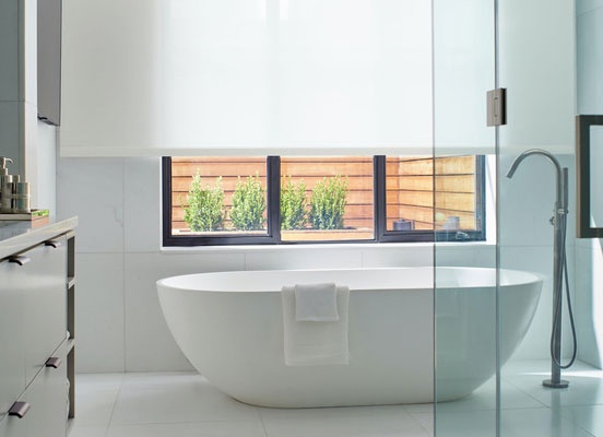Modern Barthroom with freestanding bathtub with large window fearuting Solar Shade in 1 percent material in the color White