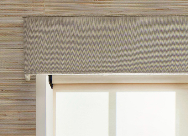 A close up of a cornice with a welt made of Baldwin in Khaki shows the details of the cornice and textured wallpaper