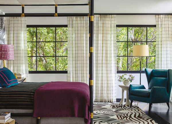 Two large windows featuring Martyn Lawrence Bullard material sahara stripe in color onyx in a colorful bedroom with zebra rug