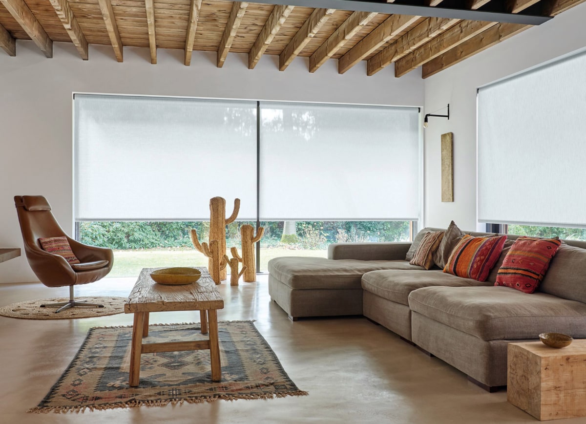 A modern, southwest-inspired living room with energy efficient 3% Thermo roller shades in Cloud.