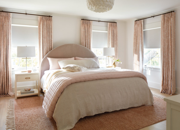 Pink and white bedroom featuring Tailored Pleat Drapery in material Chinoiserie and color Blush with large bed