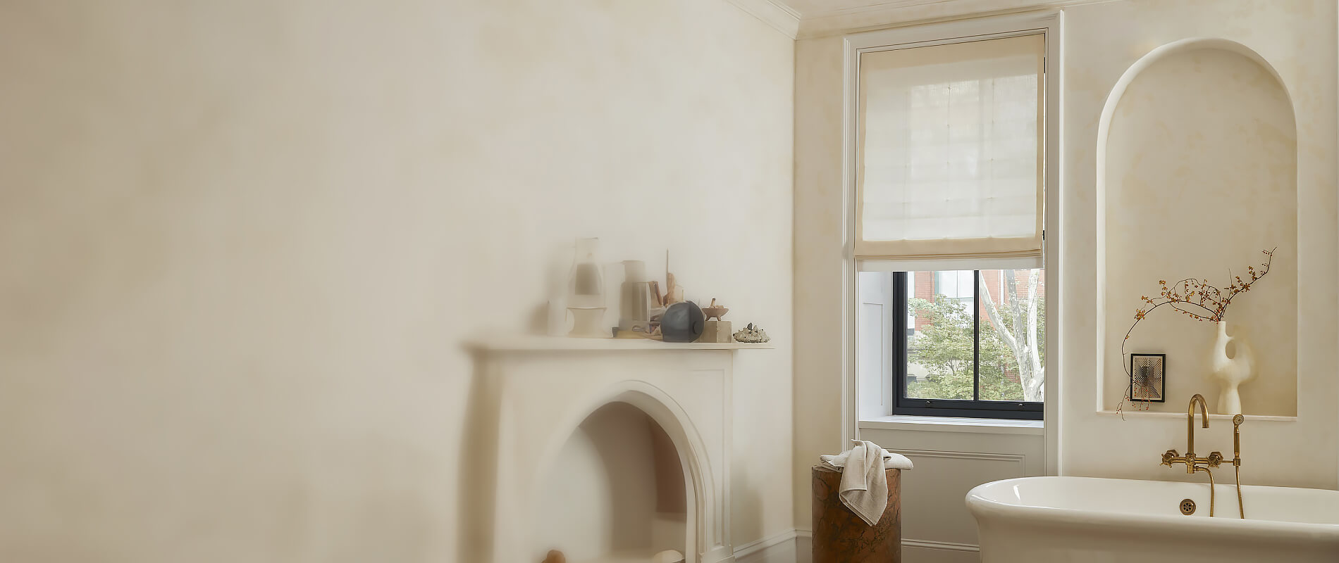 A bright bathroom with a warm ivory color scheme and a matching Flat Roman Shade in Sunbrella Ivory