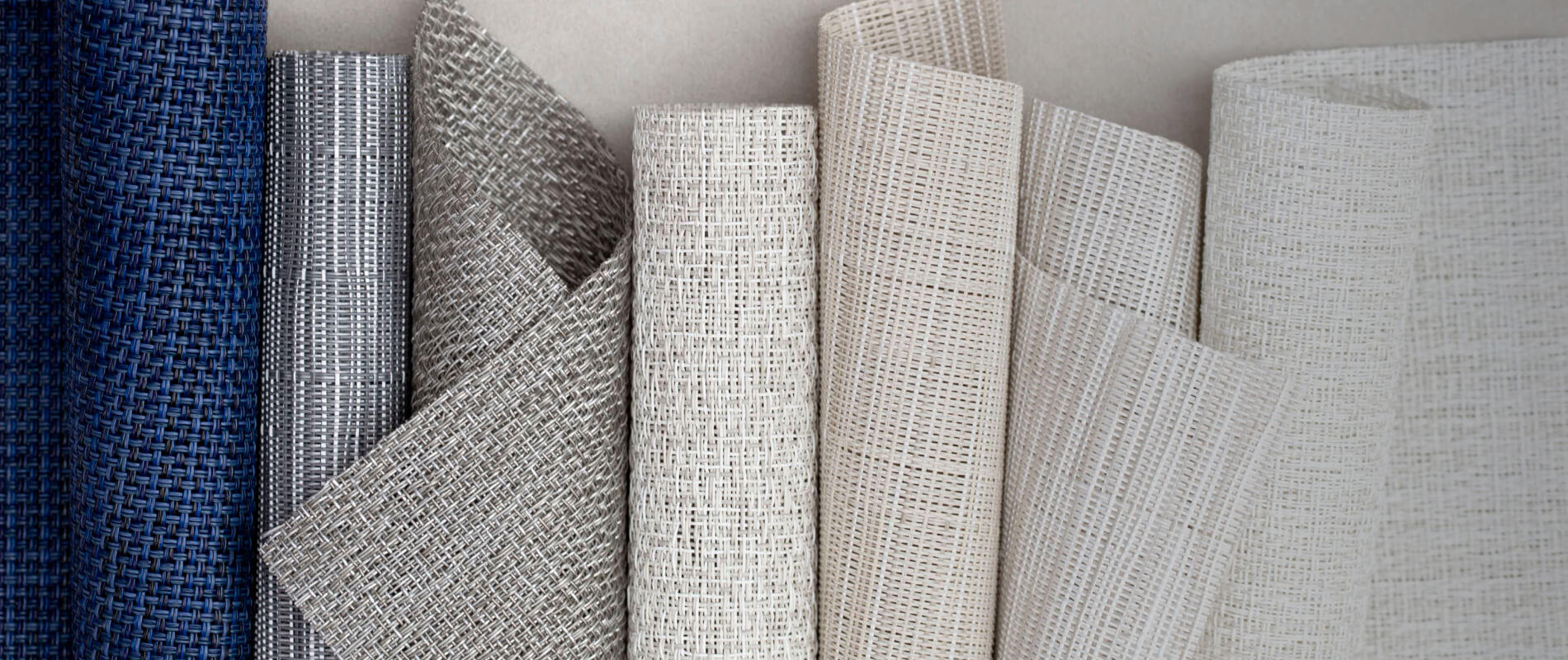  A selection of Chilewich window fabric swatches in whites, grays, and blues displayed side by side.