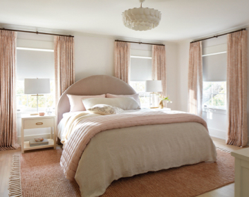 Windows featuring Tailored Pleat Drapery in Chinoiserie and Blush in a bedroom with large pink and white bed with promo text