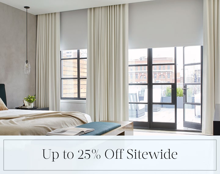 Up to 25% Off Sitewide in black text over an image of windows with Blackout Roller Shades and Drapery.