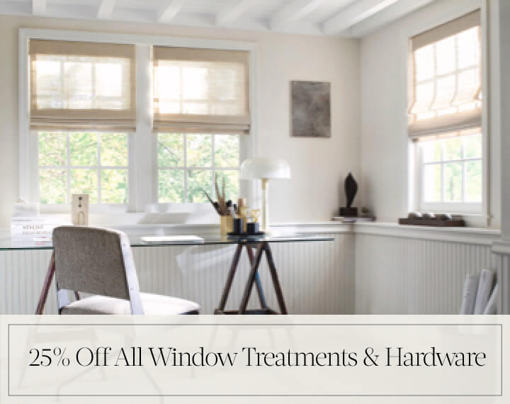 25% Off All Window Treatments & Hardware in black text over an image of Grassweave Cordless Woven Wood Shades in an office