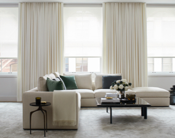 Large Windows featuring energy efficient window treatments in a living room with a large couch 