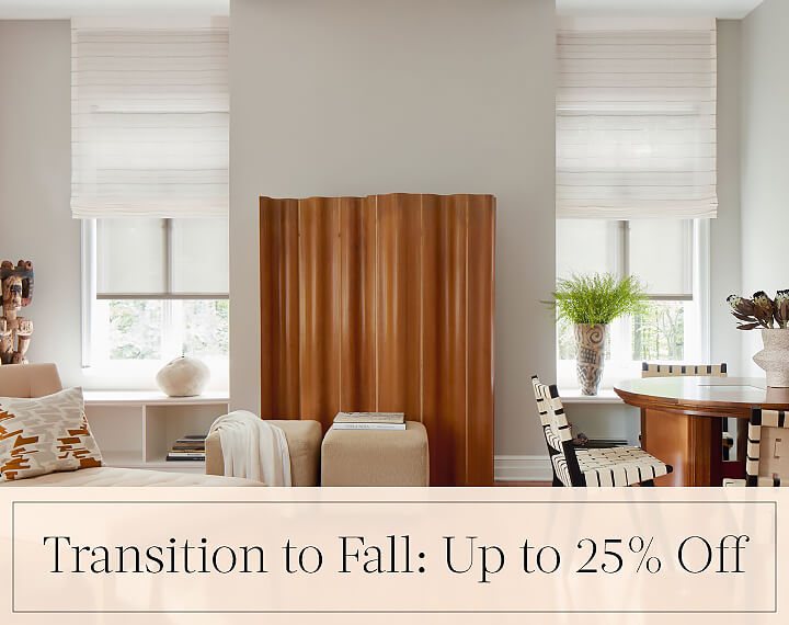 Transition to Fall: Up to 25% Off written in black text over an image of Motorized Roman and Roller Shades in a family room