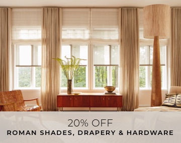 Roller Shades, Roman Shades and Drapery cover windows in a living room with lots of wood tones and overlaid sales messaging