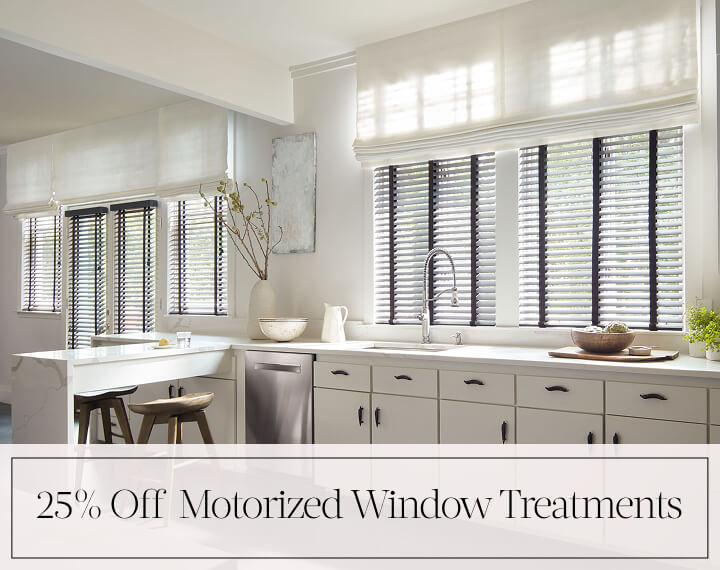 25% Off Motorized Window Treatments in black text over an image of a kitchen with Flat Roman Shades and Wood Blinds.