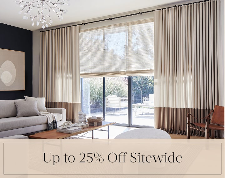 Up to 25% Off Sitewide in black text over an image of windows with Woven Wood Shades and Drapery.