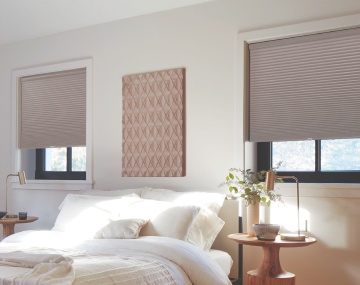 Blackout Cellular Shades in Ash hang in a contemporary bedroom with soft white and light wood tones