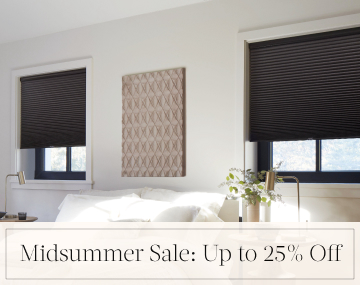 Cellular Shades in Midnight hang in a contemporary bedroom with overlaid text, Midsummer Sale: Up to 25% off