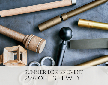 Pieces of drapery hardware in metal & wood finishes lay on a stone table with sales messaging for Summer Design Event 25% Off
