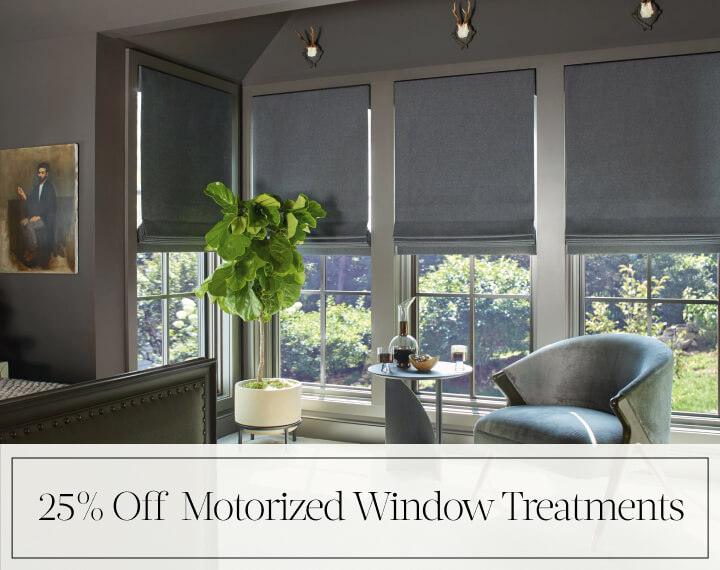 25% Off Motorized Window Treatments in black text over image of Flat Roman Wool Blend Fabric Shades on bedroom windows