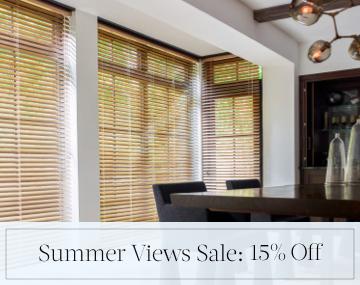 2 Inch Champagne Metal Blinds cover tall windows in a modern dining room with sales messaging for Summer Views Sale: 15% Off