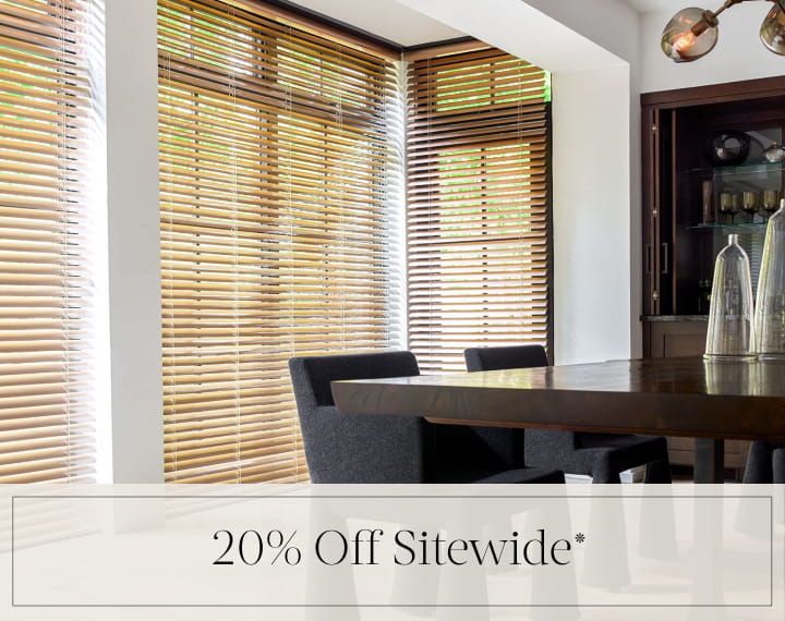 20% Off Sitewide in black text over an image of dining room windows with Champagne Metal Blinds.