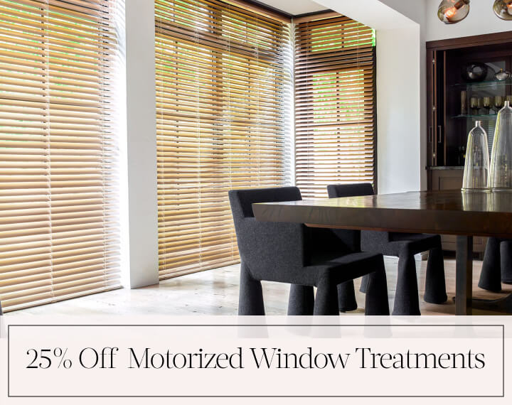 25% Off Motorized Window Treatments in black text over an image of dining room windows dressed with Champagne Metal Blinds.