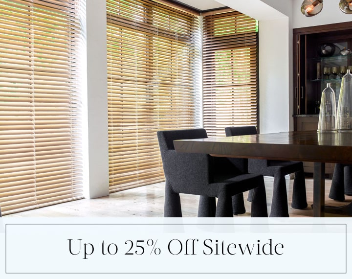 Up to 25% Off Sitewide in black text over an image of dining room windows with Champagne Metal Blinds.