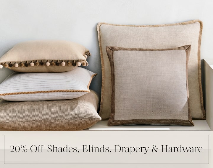 20% Off Shades, Blinds, Drapery & Hardware in black text over an image of Square Pillows in neutral fabrics with trim.