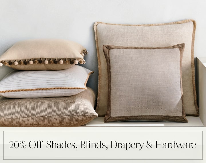 20% Off Shades, Blinds, Drapery & Hardware in black text over an image of Square Pillows in neutral fabrics with trim.