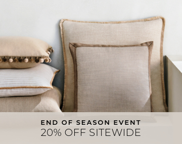 Multiple Square Pillows stacked against a white wall featuring various styles in neutral colors with 20 Percent Sitewide text