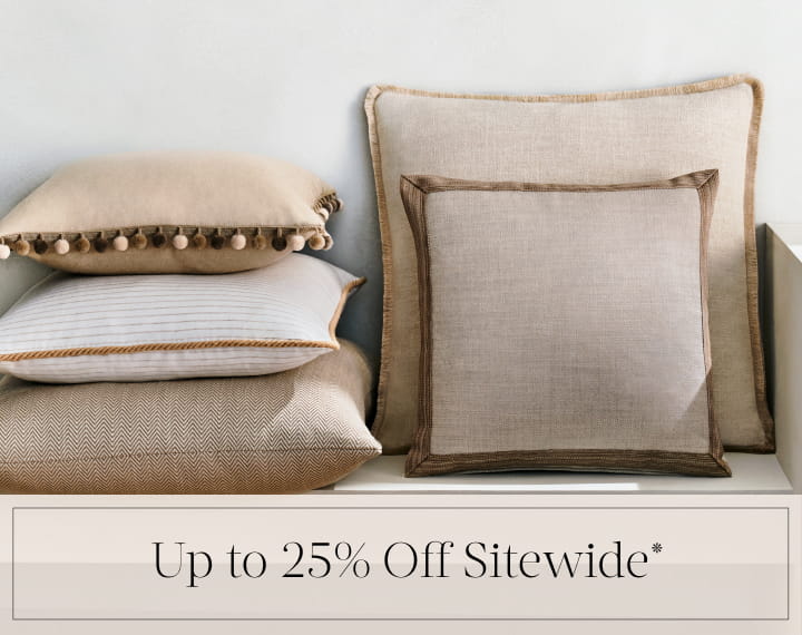 Up to 25% Off Sitewide in black text over an image of Square Pillows in neutral fabrics with trim.