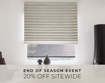 Pleated Roman Shade hung over a Roller Shade on large window with a white table and black vase with 20 Percent Sitewide text