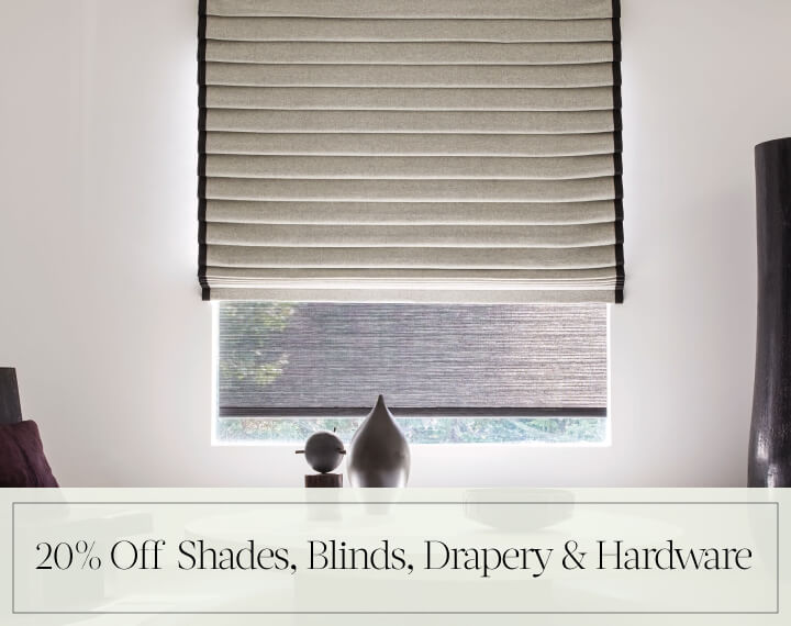 20% Off Shades, Blinds, Drapery & Hardware in black text over an image of a Pleated Roman Shade in Wool Blend in a room