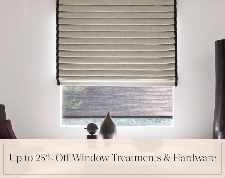 Up to 25% Off Window Treatments & Hardware in black text over an image of a Pleated Roman Shade in Wool Blend in a room