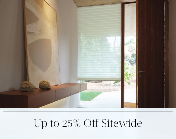 Up to 25% Off Sitewide in black text over an image of a window with a light filtering Pleated Shade.
