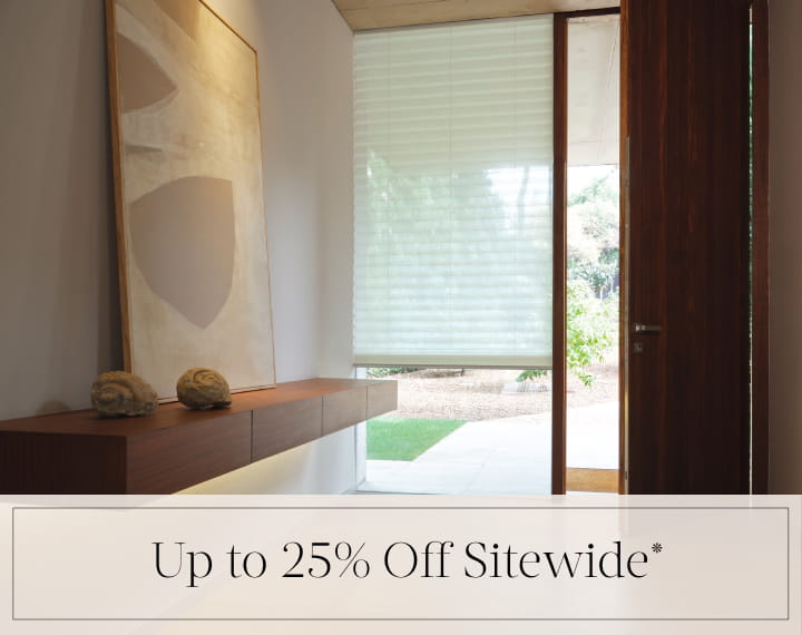 Up to 25% Off Sitewide in black text over an image of a window with a light filtering Pleated Shade.
