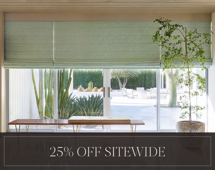25% Off Sitewide in white text over an image of living room windows with sage green Roman Shades.