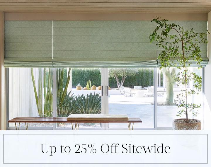 Up to 25% Off Sitewide in black text over an image of living room windows with sage green Roman Shades.