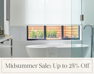 Solar Shades hang in a white bathroom with a freestanding tub with overlaid text, Midsummer Sale: Up to 25% off