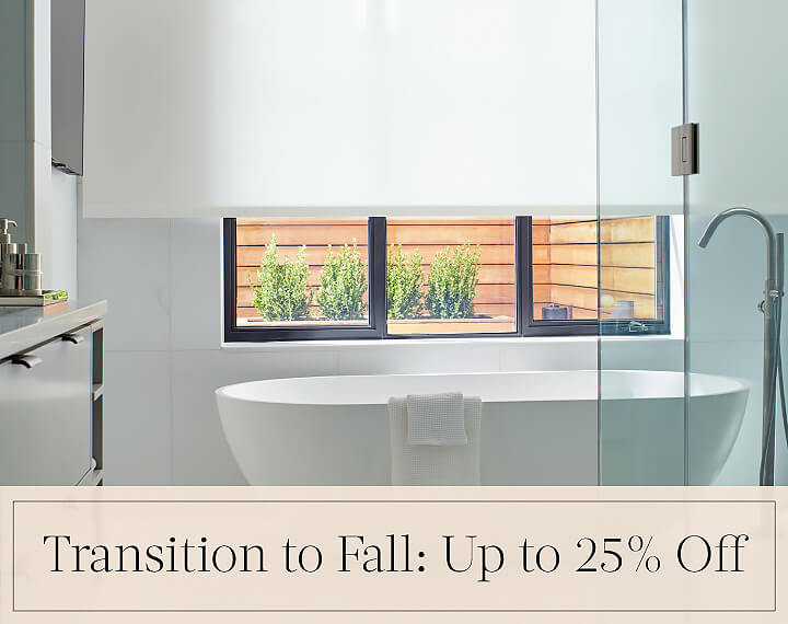 Transition to Fall: Up to 25% Off in black text over an image of Solar Shades in a white bathroom with a freestanding tub