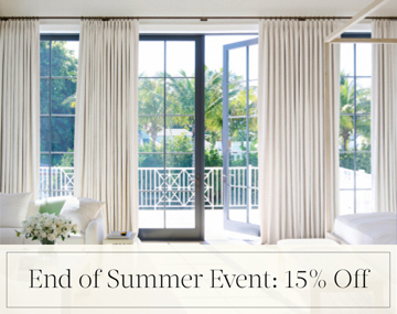 End of Summer Event: 15% Off written in black text over an image of Tailored Pleat Drapery on patio doors in a bedroom