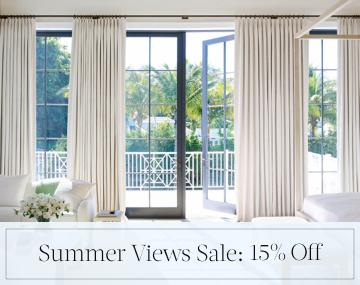 Tailored Pleat Drapery in Petal Pearl cover patio doors in a bedroom with sales messaging for Summer Views Sale: 15% Off