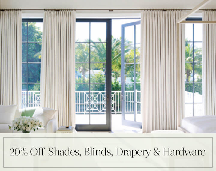 20% Off Shades, Blinds, Drapery & Hardware in black text over an image of Tailored Pleat Drapery on patio doors in a bedroom