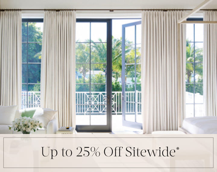Up to 25% Off Sitewide in black text over an image of Tailored Pleat Drapery on bedroom patio doors.