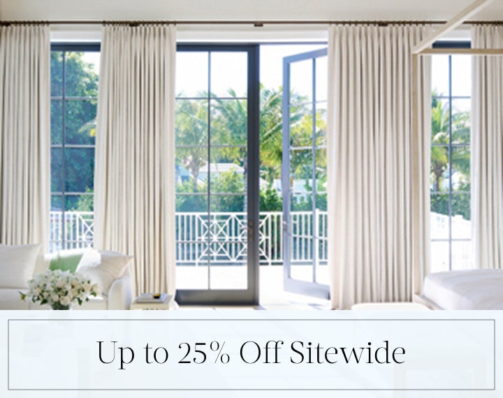 Up to 25% Off Sitewide in black text over an image of Tailored Pleat Drapery on bedroom patio doors.