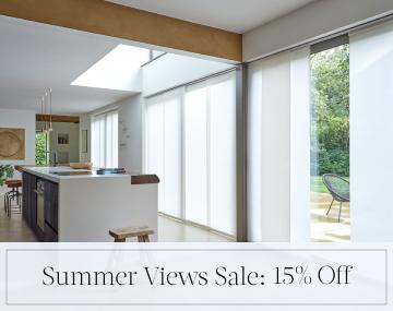 Panel Track Vertical Blinds cover large patio doors in an open kitchen with sales messaging for Summer Views Sale: 15% Off