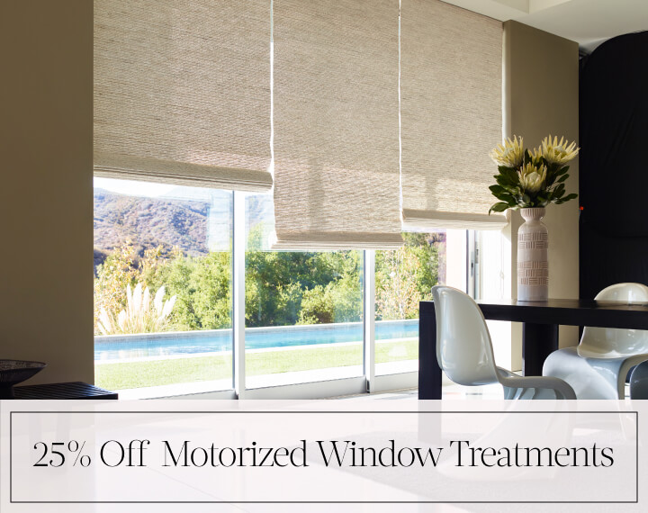 25% Off Motorized Window Treatments in black text over an image of a dining room with glass doors with Woven Wood Shades.