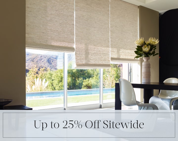 Up to 25% Off Sitewide in black text over an image of a room with glass doors with Woven Wood Shades.
