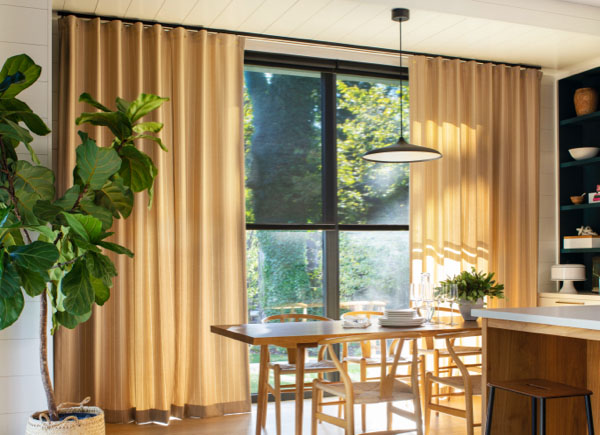 Patio doors featuring cubicle drapery in dashing stripe palomino in a dining room with a wooden table and chairs set