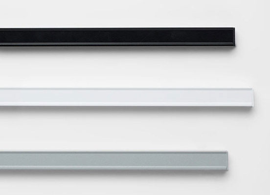 Three drapery hardware options in various Custom finishes laid out on a white table top